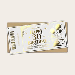 May include: A gold-foil birthday voucher with the text "Happy 30th Birthday" and a cake illustration. The voucher is on a white background with gold accents and is placed on a brown envelope.