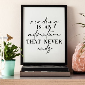 May include: Black and white framed print with the text "reading is an adventure that never ends".