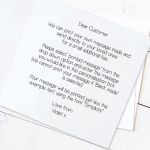 May include: A white card with black text explaining how to personalize a message for a loved one. The text reads: "Dear Customer, We can print your own message inside and send directly to your loved ones for a small additional fee. Please select 'printed message' from the drop down option and enter the message you would like in the personalisation box. We cannot print your message if 'Blank inside' is selected. Your message will be printed just like this example text using the font "Simplicity". Love from Violet x"