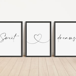 May include: Three black framed prints with white backgrounds. The left print says "Sweet" in cursive. The middle print has a simple line drawing of a heart. The right print says "dreams" in cursive.
