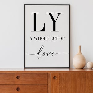 May include: Black and white printable wall art with the text "LY A WHOLE LOT OF love" in a modern font.