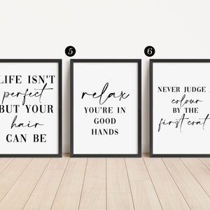 May include: Three black framed prints with white backgrounds and black text. The first print says "Life isn't perfect but your hair can be". The second print says "Relax you're in good hands". The third print says "Never judge a color by the first coat".