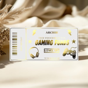 May include: A white and gold gaming voucher with the name "Archie" at the top. The voucher includes the text "This voucher is for Gaming Funds" and features illustrations of a headset, a star, a lightning bolt, and a game controller.