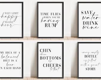 May include: Six black framed prints with white backgrounds and black text. The prints feature humorous sayings about alcohol, such as "Why limit happy to one hour?" and "Save water, drink wine."