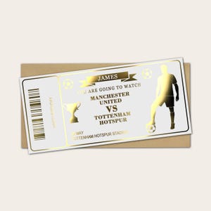 May include: A gold-coloured birthday card designed as a football ticket. It features the text "JAMES", "Manchester United vs Tottenham Hotspur", and a graphic of a footballer. The card is on a brown envelope.