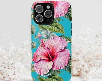 May include: A phone case featuring a vibrant floral design. The case has a turquoise background with large pink hibiscus flowers and green leaves. The phone case is designed to fit a modern smartphone with multiple camera lenses.