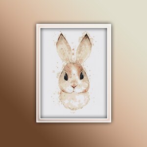 May include: A watercolour painting of a brown rabbit with large ears. The rabbit is looking directly at the viewer with a soft expression. The background is a white canvas with subtle watercolour splatters.