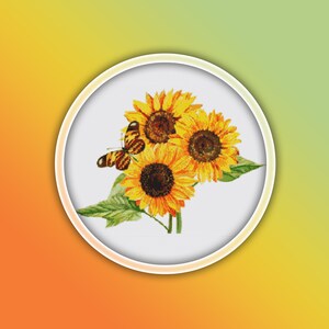 May include: A white circle with a white border surrounds a bouquet of three yellow sunflowers with brown centers and a brown and orange butterfly. The background is a gradient of orange and yellow.