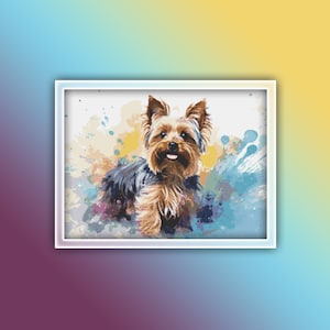 Puede incluir: Un perro Yorkshire Terrier con pelaje marrón y negro está de pie en una pintura de estilo acuarela con salpicaduras de color azul, amarillo y blanco.