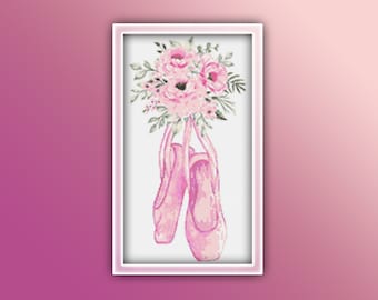 May include: A pair of pink ballet shoes with a bouquet of pink flowers hanging from the toes.