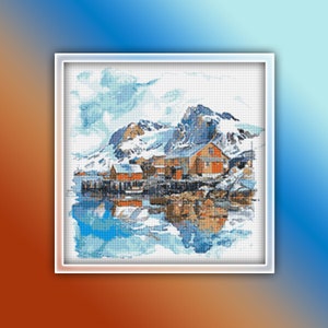 May include: A cross-stitch pattern depicting a snowy mountain scene with a small village at the foot. The village includes a red-roofed house and a wooden jetty reaching out into the water. The sky is a pale blue with fluffy white clouds.