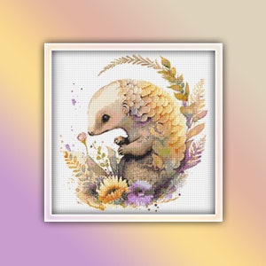 May include: A cute, cartoon-style pangolin with yellow and brown scales is surrounded by watercolor flowers and leaves. The pangolin is looking at a purple flower.
