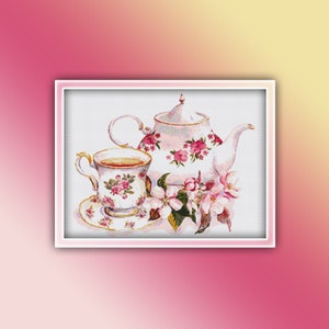 May include: A white teapot and teacup with pink floral designs, surrounded by white blossoms with green leaves.