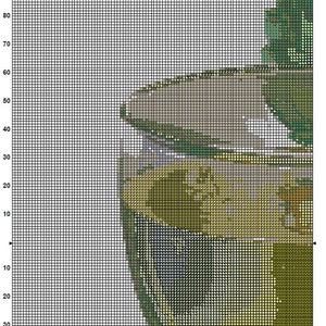 May include: A cross-stitch pattern for a green tea cup with a brown handle and a green tea leaf design. The pattern is on a white grid with black lines.