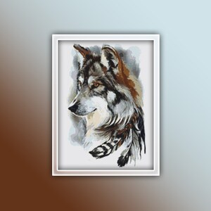 May include: A close-up of a wolf's head with a gray and brown fur pattern. The wolf is looking to the side and has a few feathers around its neck.