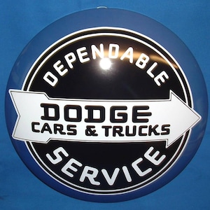 May include: A circular sign for Dodge service, predominantly blue and black. The white text reads "Dependable Dodge Cars & Trucks Service", with an arrow pointing right. The sign has a shiny surface.