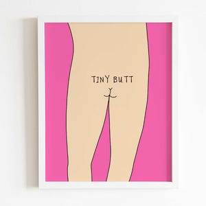 May include: A framed wall art print featuring a minimalist line drawing of a lower torso against a vibrant hot pink background. The illustration is colored in a light beige tone and includes the black text "TINY BUTT" centered above the gluteal cleft.
