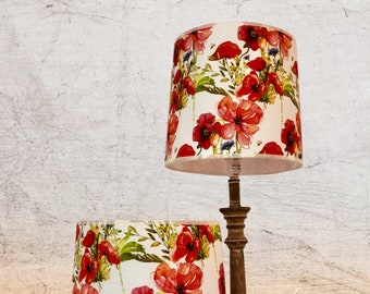 Drum-shaped lampshades, laminated on a cotton fabric with poppy motifs.