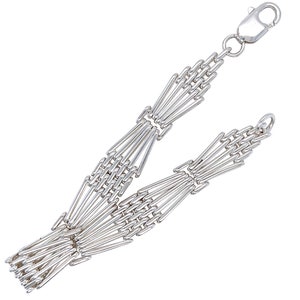 Puede incluir: Un brazalete de cadena de plata con un diseño geométrico único. La cadena está hecha de múltiples hebras de eslabones finos e interconectados que forman un patrón repetitivo.