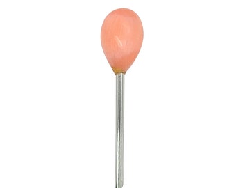 May include: A single, pink glass-headed pin with a silver metal shaft.