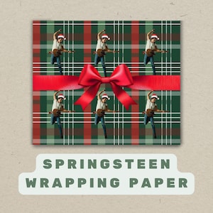May include: Wrapping paper featuring a plaid pattern in green, red, and white, adorned with a red bow. The design includes multiple images of a person playing a guitar and wearing a Santa hat. The text "SPRINGSTEEN WRAPPING PAPER" is displayed.