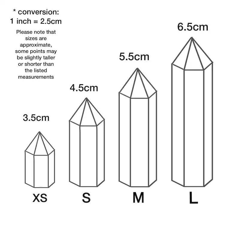 May include: Four crystal obelisks of varying sizes, labeled XS, S, M, and L. The smallest is 3.5cm tall, the next is 4.5cm, the third is 5.5cm, and the largest is 6.5cm. The image includes a conversion note: 1 inch = 2.5cm.