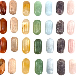 May include: A set of 24 tumbled stones in various colours, including red, orange, yellow, green, blue, purple, and pink. The stones are arranged in a grid pattern on a white background.
