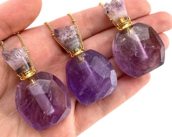 May include: Three amethyst crystal bottle necklaces with gold chains and stoppers. The bottles are faceted and have a purple hue.