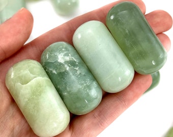 May include: Five smooth, polished green jade stones in various shades of green. The stones are oval shaped and have a smooth, polished finish.