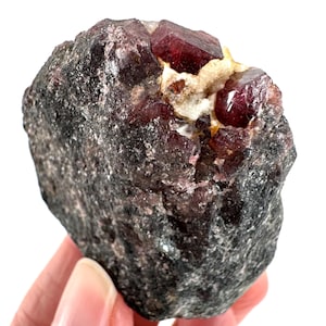 May include: A set of three ceramic mugs with a speckled, matte finish. The mugs are in shades of cream, light gray, and dark gray. Each mug has a simple, minimalist design, perfect for coffee or tea.