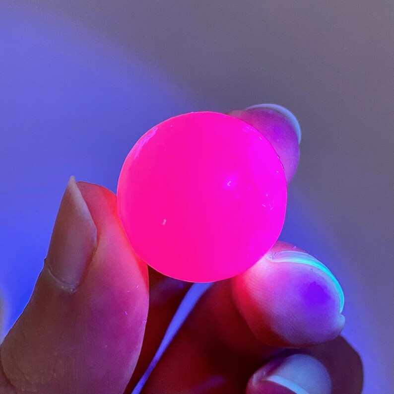 May include: A bright pink, round, bouncy ball.
