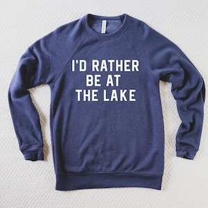 May include: A navy blue sweatshirt with the text "I'd rather be at the lake" printed in white on the front.