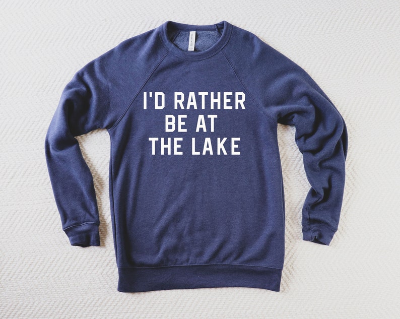 May include: A navy blue sweatshirt with the text "I'd rather be at the lake" printed in white on the front.