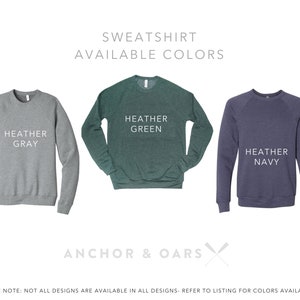 Puede incluir: Tres sudaderas de diferentes colores: gris jaspeado, verde jaspeado y azul marino jaspeado. El texto "SWEATSHIRT AVAILABLE COLORS" est&aacute; en la parte superior de la imagen. El texto "ANCHOR & OARS" est&aacute; en la parte inferior de la imagen.