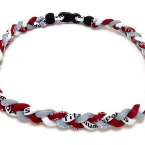 May include: A red, white, and gray braided lanyard with the words "Titanium Sports" repeated on the braid.