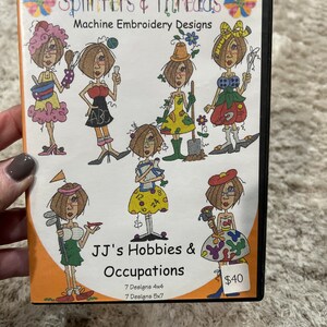 May include: A DVD case with a colorful design featuring cartoon characters and the text "Splinters & Threads Machine Embroidery Designs" and "JJ's Hobbies & Occupations 7 Designs 4x4 7 Designs 5x7 $40".