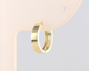 May include: A gold hoop earring with a smooth, polished finish.