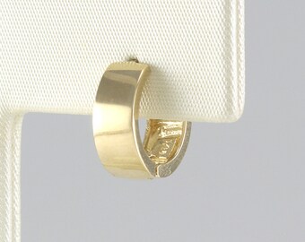 May include: A gold hoop earring with a smooth, polished finish.