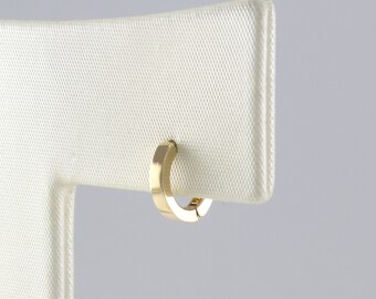 May include: A gold hoop earring with a square shape.