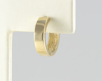 May include: A gold hoop earring with a smooth, polished finish. The earring is shown on a white display stand.