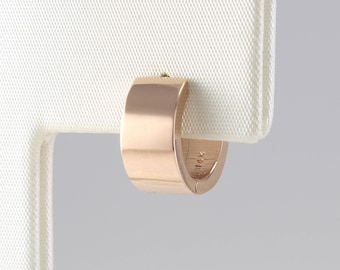 May include: A pair of rose gold hoop earrings. The earrings are simple and elegant, with a smooth, polished finish.
