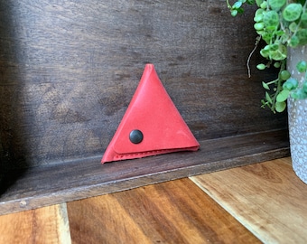Leather triangle coin purse made of thick plain red leather.
