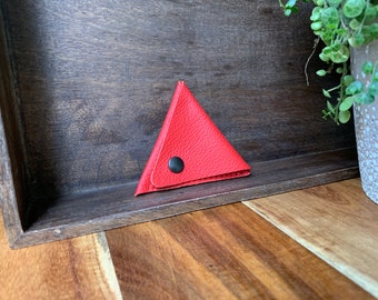 Leather triangle coin purse made of thin red leather.