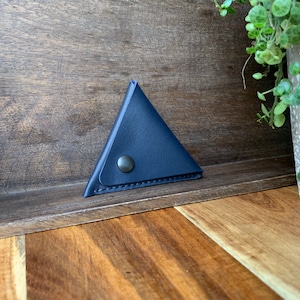 Leather triangle coin purse made of navy blue leather.