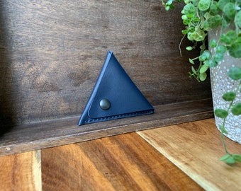 Leather triangle coin purse made of navy blue leather.