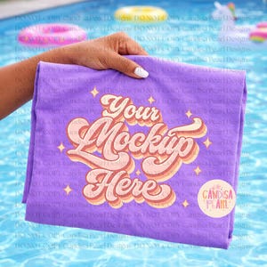 May include: A folded lilac t-shirt featuring the text "Your Mockup Here" in a vintage style. The design includes starbursts and a circular logo. The shirt is held up against a pool background.