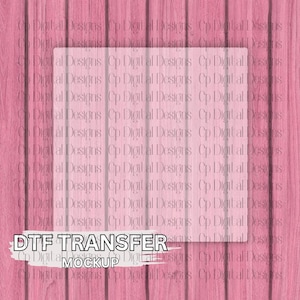 May include: Pink wooden background with a transparent square overlay. The text "DTF TRANSFER MOCKUP" is displayed in a white font at the bottom of the image. The background has a vertical wood grain pattern.