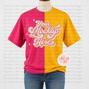 May include: A short-sleeve t-shirt featuring a split-color design with a magenta left side and a golden yellow right side. The center displays the text "Your Mockup Here" in a stylized script font, accented by small four-pointed star graphics.