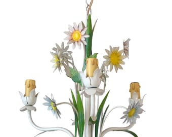 May include: White metal chandelier with a floral design. The chandelier has three lights and features yellow, green, and white flowers.