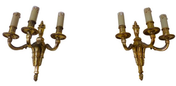 Gorgeous antique French pair of gilt bronze wall lights, circa 1930, triple Louis XVI style.